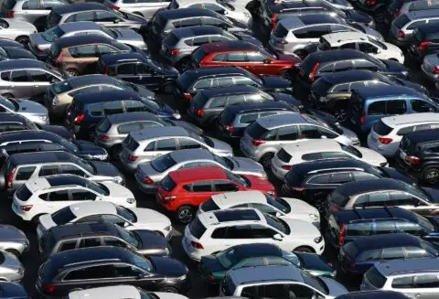 Crowded car park with various parked vehicles
