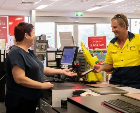 Customer paying at office supplies store counter