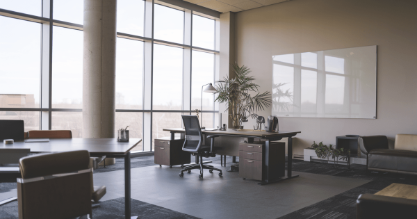 Modern office with desk, chair and large windows