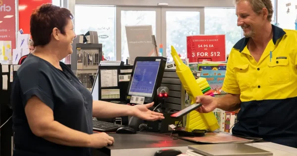 Customer receiving assistance at a retail counter.