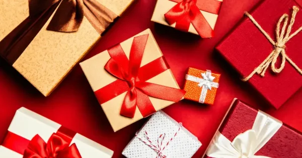 Colourful gift boxes with ribbons on red background